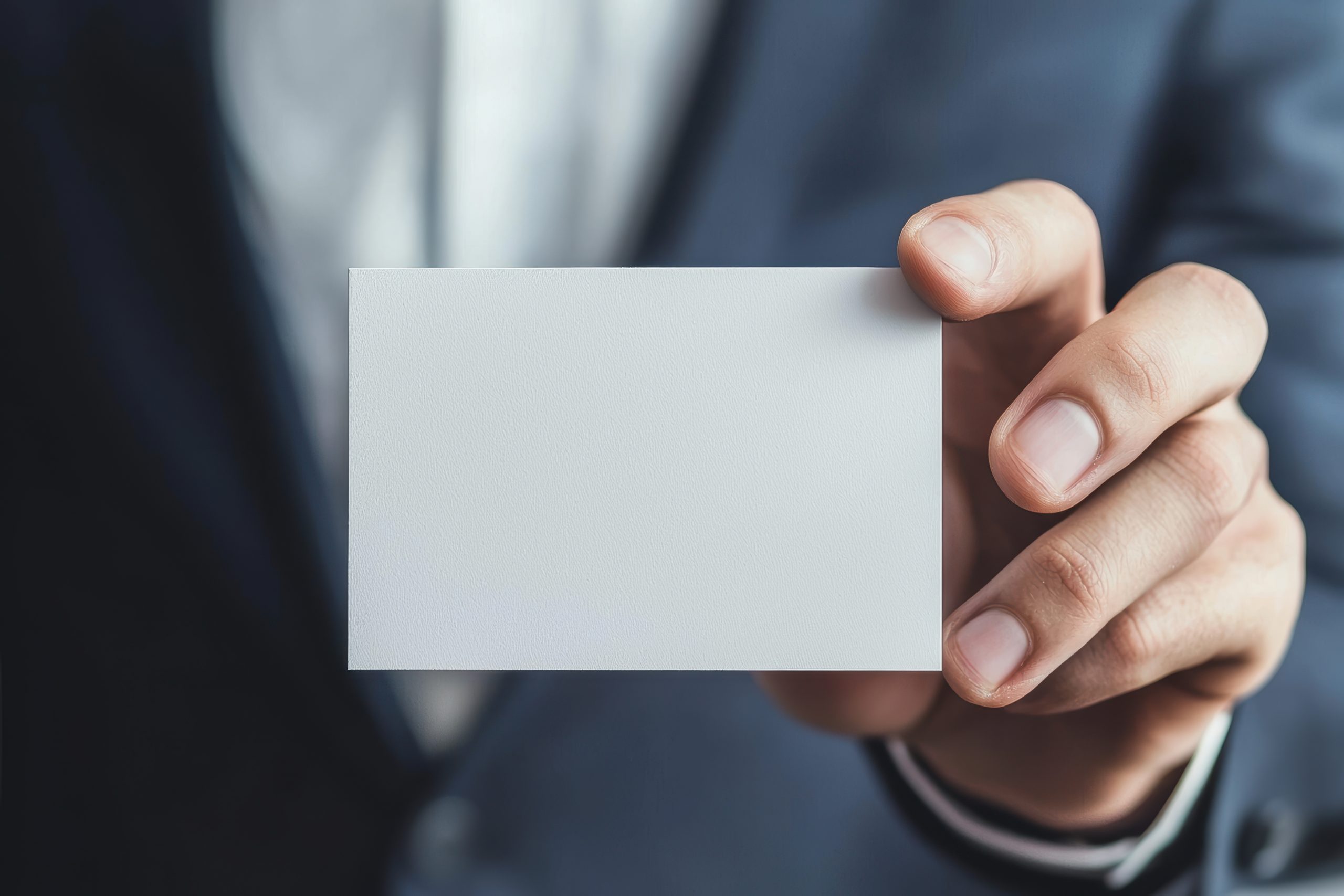 Hand holding a blank business card